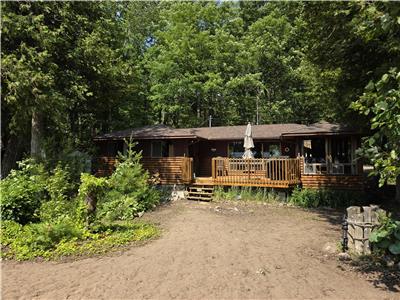 Waterfront cottage with private sand beach in quiet Kawartha setting