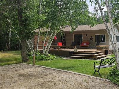4 season cottage in a park-like setting with short walking distance to the lake and sandy beach