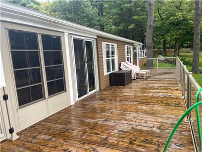 This resort cottage features an expansive wrap around deck, and an additional add-on room!
