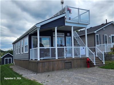 This luxurious resort cottage model offers beautiful views of Rice Lake!