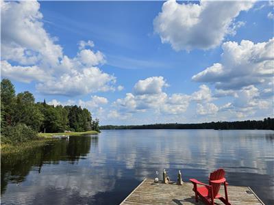 Cozy waterfront cottage on level property with sandy beach, great fishing, boating, snowmobiles