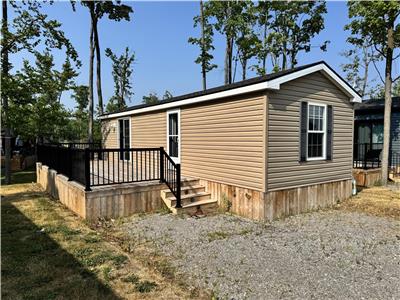 Step into your own oasis nestled in the forest with this resort cottage!